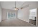 The main bedroom has a bathroom nearby, carpeted floors, ceiling fan, and backyard access at 1004 Black Knight Dr, Valrico, FL 33594