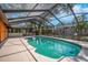 Screened in pool area with blue water and a concrete deck at 1004 Black Knight Dr, Valrico, FL 33594