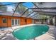 The pool area features a clear water in a screened enclosure, with a concrete deck and home access at 1004 Black Knight Dr, Valrico, FL 33594