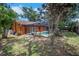 View of the screened-in pool and patio area of the backyard, set against lush green landscaping at 1004 Black Knight Dr, Valrico, FL 33594