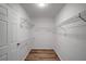 Walk-in closet with wire shelving and wood flooring at 1004 Black Knight Dr, Valrico, FL 33594
