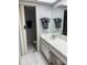 Bright bathroom with white tile, a large mirror, and clean, modern fixtures at 105 Lakeview Way # 105, Oldsmar, FL 34677