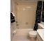 Full bathroom featuring a shower/tub combination with tiled walls and a neutral-colored floor at 105 Lakeview Way # 105, Oldsmar, FL 34677