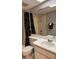 Bright bathroom with a large mirror and a shower/tub combo featuring a stylish black curtain at 105 Lakeview Way # 105, Oldsmar, FL 34677