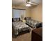 Cozy bedroom features twin beds, neutral tones, and a ceiling fan for added comfort at 105 Lakeview Way # 105, Oldsmar, FL 34677