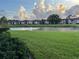 Picturesque community view showcasing a pond, green spaces, and low-rise residential buildings at 105 Lakeview Way # 105, Oldsmar, FL 34677