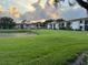 Lush green lawns and a pond are complemented by multi-story residential buildings at 105 Lakeview Way # 105, Oldsmar, FL 34677