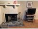Stone fireplace and tv set, creating a great atmosphere for any living space at 105 Lakeview Way # 105, Oldsmar, FL 34677