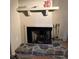 Cozy fireplace with stone base and white mantel, perfect for a relaxing evening at 105 Lakeview Way # 105, Oldsmar, FL 34677