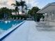 Community pool surrounded by palm trees and lounge chairs, providing a perfect spot for relaxation at 105 Lakeview Way # 105, Oldsmar, FL 34677