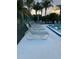 Relaxing poolside featuring comfortable lounge chairs, perfect for enjoying sunny days in a tranquil setting at 105 Lakeview Way # 105, Oldsmar, FL 34677