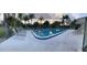 Inviting community pool with lounge chairs, offering a relaxing outdoor space surrounded by palm trees at 105 Lakeview Way # 105, Oldsmar, FL 34677