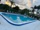 Inviting community swimming pool surrounded by lush landscaping and comfortable lounge chairs at 105 Lakeview Way # 105, Oldsmar, FL 34677