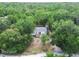 Aerial view of home showing treed property with white residence and private yard at 10537 Fran St, New Port Richey, FL 34654