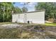 Exterior of home showing the backyard with a small lawn, surrounded by trees at 10537 Fran St, New Port Richey, FL 34654