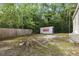 View of the backyard, featuring a storage unit and ample green space at 10537 Fran St, New Port Richey, FL 34654