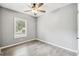 Neutral bedroom with hardwood floors and a bright window offering views of the outside at 10537 Fran St, New Port Richey, FL 34654