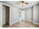Bedroom boasting hardwood floors, neutral walls, a ceiling fan, and an adjacent walk-in closet at 10537 Fran St, New Port Richey, FL 34654