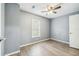 Bedroom with hardwood floors, neutral paint, ceiling fan, and a bright window at 10537 Fran St, New Port Richey, FL 34654