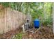 Exterior of home with well pump with blue water storage tank and new plumbing at 10537 Fran St, New Port Richey, FL 34654