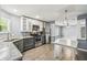 Well lit kitchen features stainless steel appliances, stone countertops, and grey wood flooring at 10537 Fran St, New Port Richey, FL 34654