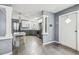 Open kitchen space features stainless steel appliances, stone countertops, and grey wood flooring at 10537 Fran St, New Port Richey, FL 34654