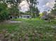 Spacious backyard featuring beautiful green space and a single-story house at 11107 Riverview Dr, Riverview, FL 33578