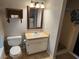 Simple bathroom with toilet, vanity with sink, and small shower at 11107 Riverview Dr, Riverview, FL 33578