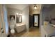 Bathroom featuring a toilet, vanity, mirror, and tile flooring at 11107 Riverview Dr, Riverview, FL 33578