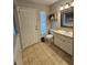 Well-lit half bathroom with a tiled floor, vanity, sink and toilet next to a window at 11107 Riverview Dr, Riverview, FL 33578
