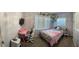 This cozy bedroom features lots of natural light, comfortable furnishings, and a unique decor at 11107 Riverview Dr, Riverview, FL 33578