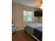 This is a bedroom with neutral walls, ceiling fan, TV, and a window with outside light at 11107 Riverview Dr, Riverview, FL 33578