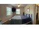 This bedroom features a sunlit window, ceiling fan, a TV and a comfortable bed at 11107 Riverview Dr, Riverview, FL 33578