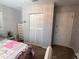 Bedroom with door to the hall and built-in closet with louvered doors at 11107 Riverview Dr, Riverview, FL 33578