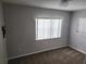 Bedroom features a window for natural light and cozy carpeting at 11107 Riverview Dr, Riverview, FL 33578