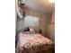 Bedroom with pastel pink bedspread, white painted dresser, and louvered blinds at 11107 Riverview Dr, Riverview, FL 33578