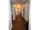 Inviting hallway with wood flooring, connecting various rooms in the home at 11107 Riverview Dr, Riverview, FL 33578