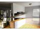 Split image of a kitchen featuring neutral tones and stainless steel appliances at 11107 Riverview Dr, Riverview, FL 33578
