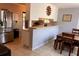 Functional kitchen with breakfast bar, stainless steel refrigerator, and dining area at 11107 Riverview Dr, Riverview, FL 33578