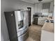 Functional kitchen with stainless steel refrigerator and appliances, plus white cabinetry at 11107 Riverview Dr, Riverview, FL 33578