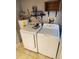 Convenient laundry area with washer, dryer, and shelving for storage at 11107 Riverview Dr, Riverview, FL 33578