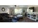 Open-concept living room with stylish decor, wood flooring, and ample natural light at 11107 Riverview Dr, Riverview, FL 33578