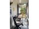 Cozy porch with outdoor seating and a view of the lush garden at 11107 Riverview Dr, Riverview, FL 33578