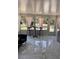 Bright sunroom with marble tile and furniture, surrounded by windows offering views of the outdoors at 11107 Riverview Dr, Riverview, FL 33578