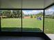 A serene view of a large backyard with lush grass, framed by a screened-in enclosure at 11210 Mcmullen Rd, Riverview, FL 33569