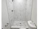 Elegant bathroom shower featuring new stylish marble-look tile and modern fixtures with handheld sprayer at 11210 Mcmullen Rd, Riverview, FL 33569