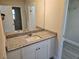 Bathroom featuring granite counters, white cabinets, and a mirror over the sink, with a view of the closet at 11210 Mcmullen Rd, Riverview, FL 33569