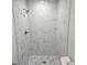 Elegant bathroom shower featuring new stylish marble-look tile and modern fixtures with handheld sprayer at 11210 Mcmullen Rd, Riverview, FL 33569