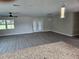 Spacious living room featuring luxury vinyl plank flooring, a modern ceiling fan, and large windows at 11210 Mcmullen Rd, Riverview, FL 33569