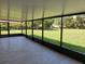 Spacious screened-in porch features neutral tile flooring and expansive views of the backyard at 11210 Mcmullen Rd, Riverview, FL 33569